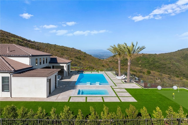 view of swimming pool with a mountain view and a patio