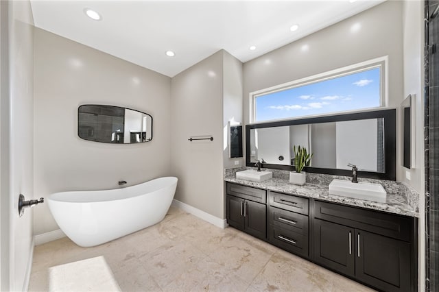 bathroom with vanity and shower with separate bathtub