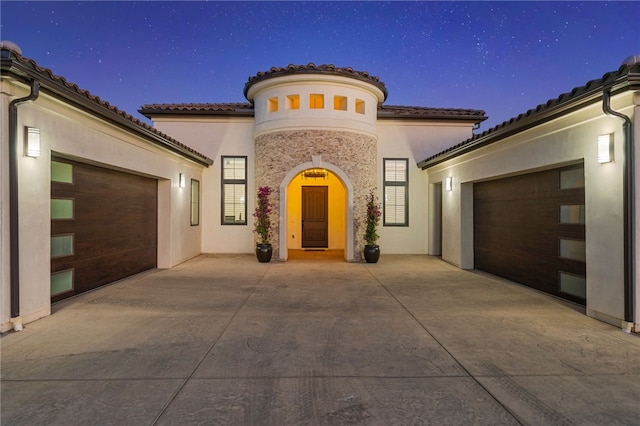 exterior entry at night with a garage