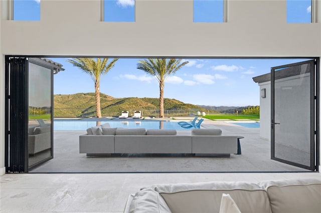 view of patio / terrace with a mountain view and an outdoor hangout area