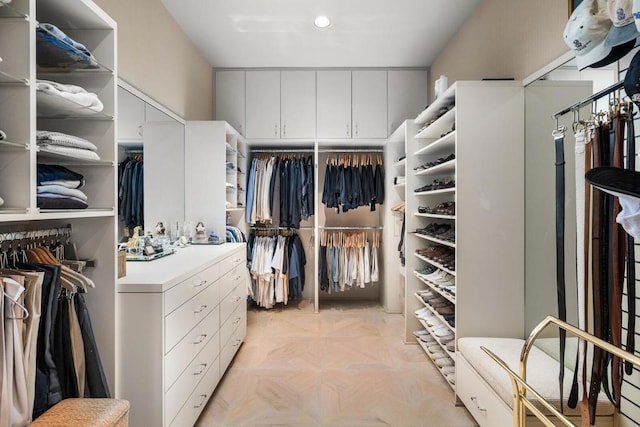 spacious closet with light parquet flooring