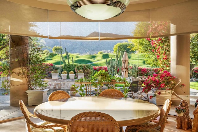 dining area with a healthy amount of sunlight and a mountain view