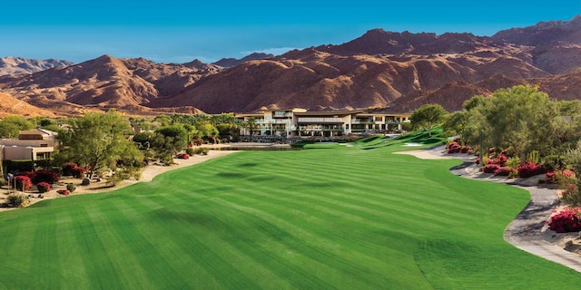 view of property's community featuring a mountain view and a lawn