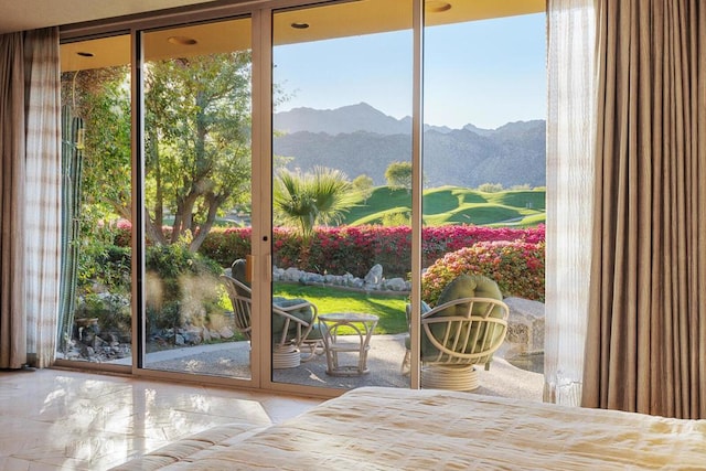 doorway to outside featuring a mountain view and floor to ceiling windows