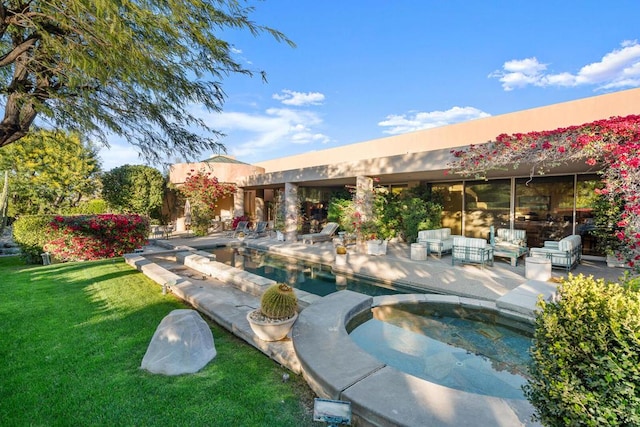 view of swimming pool featuring an in ground hot tub, a yard, an outdoor hangout area, and a patio