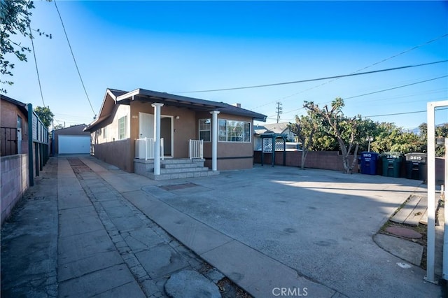 bungalow with a garage and an outdoor structure