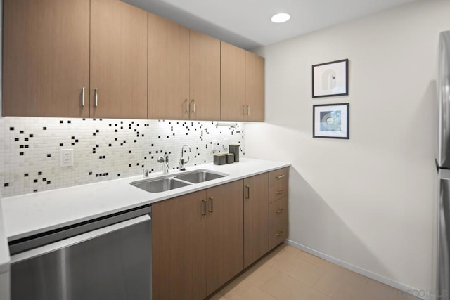 kitchen featuring light tile patterned floors, tasteful backsplash, stainless steel dishwasher, and sink