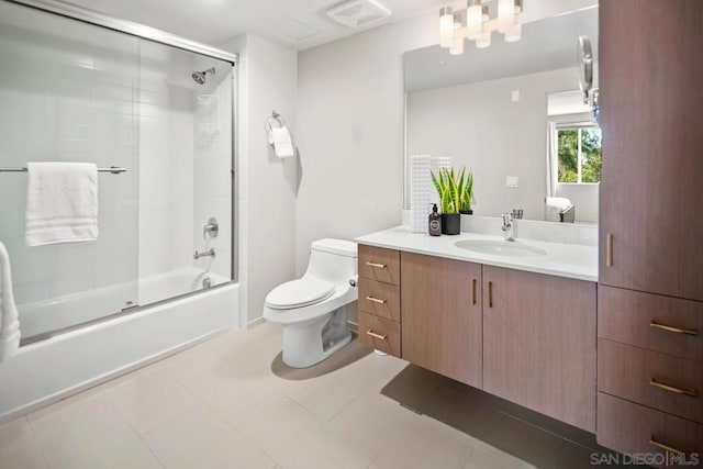 full bathroom with tile patterned floors, vanity, enclosed tub / shower combo, and toilet