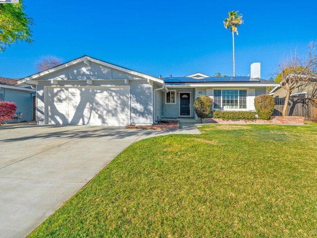 single story home featuring a garage, a front lawn, and solar panels