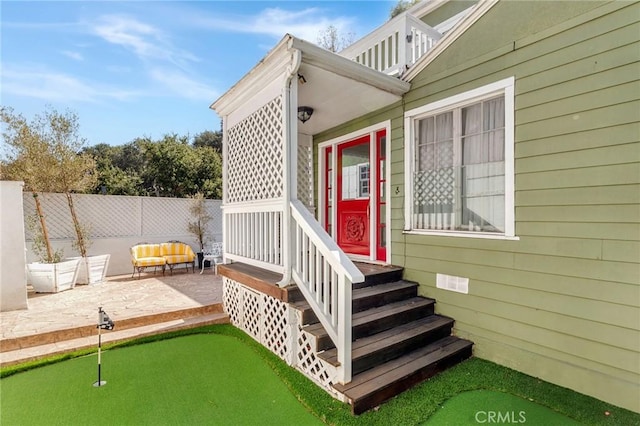 property entrance with a patio