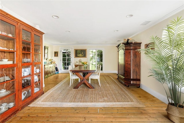 dining room featuring crown molding and light wood-type flooring