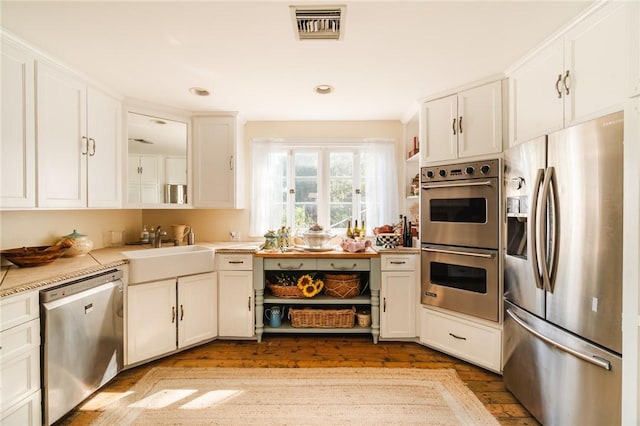 kitchen featuring white cabinets, stainless steel appliances, and sink