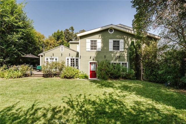 rear view of house with a lawn