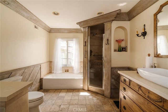 full bathroom featuring vanity, toilet, and independent shower and bath