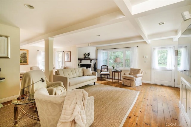 living room with beamed ceiling, light hardwood / wood-style floors, and coffered ceiling