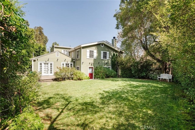 rear view of property with a yard and french doors