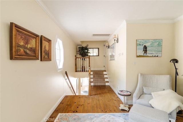 corridor featuring light hardwood / wood-style flooring and crown molding