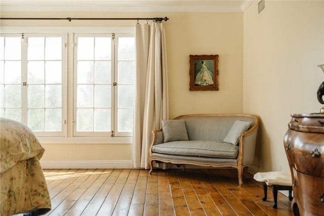 sitting room featuring hardwood / wood-style floors and crown molding