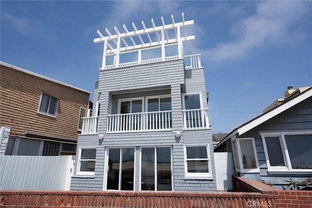 back of house featuring a balcony