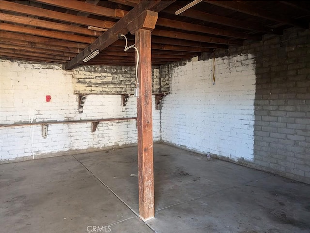 basement with brick wall