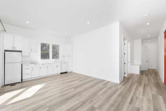 interior space with sink and light hardwood / wood-style floors