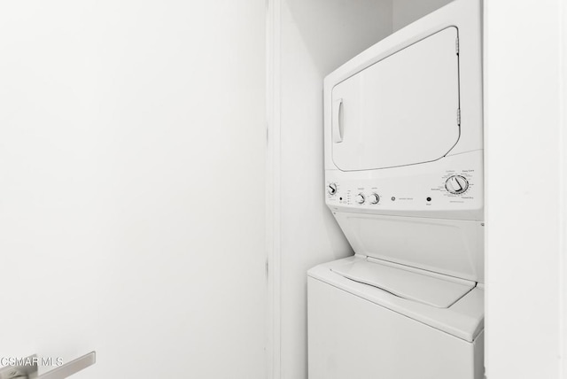 laundry area featuring stacked washing maching and dryer