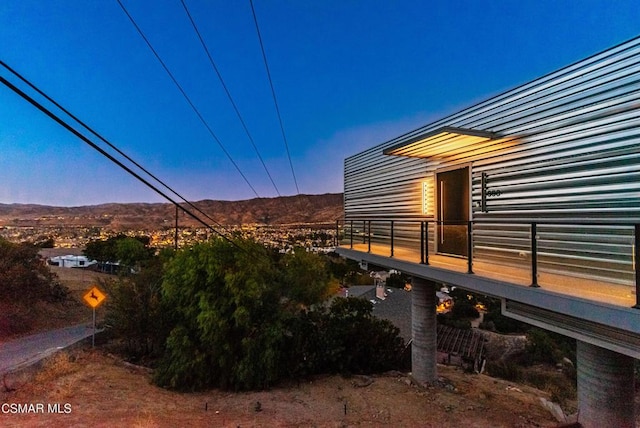 property exterior at dusk with a mountain view