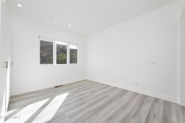 unfurnished room with light hardwood / wood-style flooring