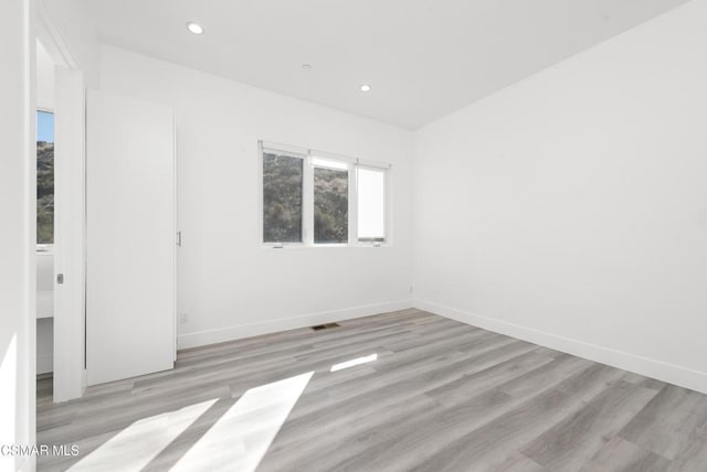 unfurnished room featuring light hardwood / wood-style floors