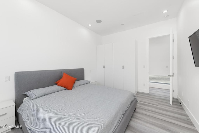 bedroom with light hardwood / wood-style floors