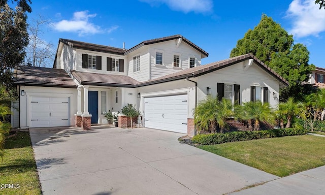 view of front property featuring a garage and a front yard