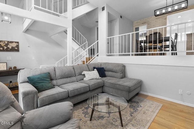 living room with a high ceiling and hardwood / wood-style floors