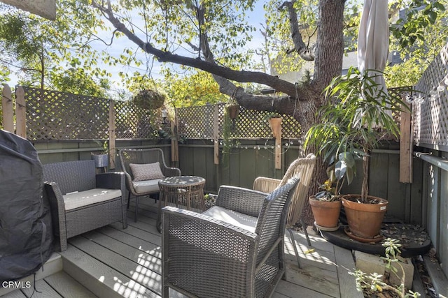 deck featuring fence and an outdoor hangout area