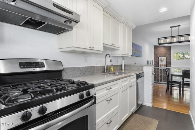 kitchen featuring a sink, exhaust hood, white cabinetry, appliances with stainless steel finishes, and light stone countertops