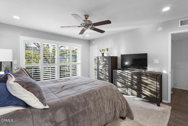 bedroom with recessed lighting, visible vents, baseboards, and wood finished floors