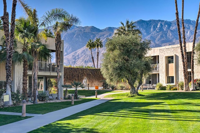 surrounding community featuring a mountain view and a lawn