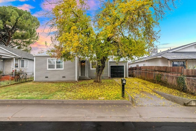 view of front of home with a lawn and a garage