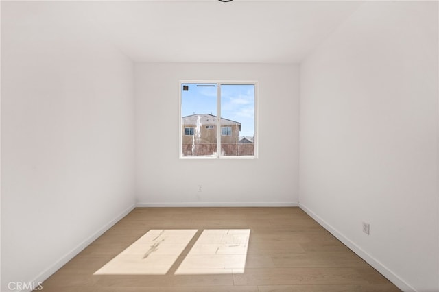 unfurnished room featuring light wood-style floors and baseboards