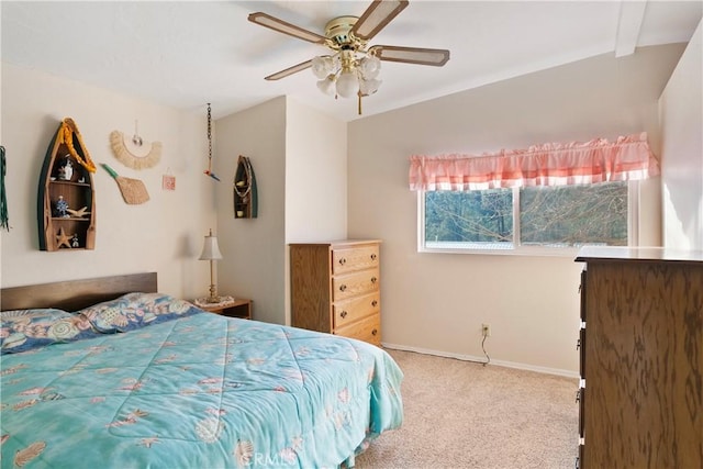 carpeted bedroom with vaulted ceiling and ceiling fan