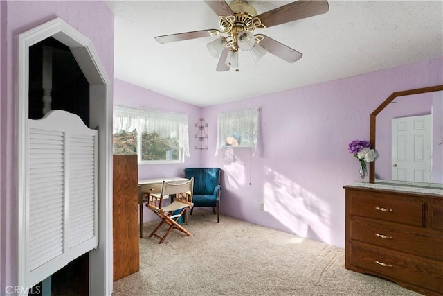 carpeted bedroom with vaulted ceiling and ceiling fan