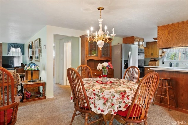 dining room featuring an inviting chandelier and light colored carpet