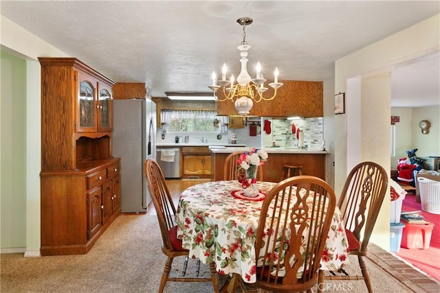 dining area with light colored carpet and a notable chandelier