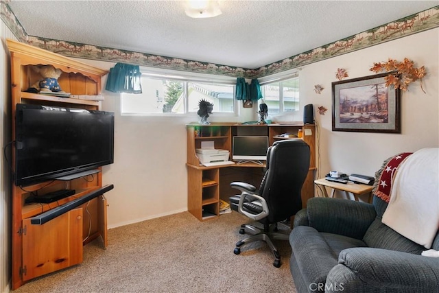 home office with a textured ceiling and carpet flooring