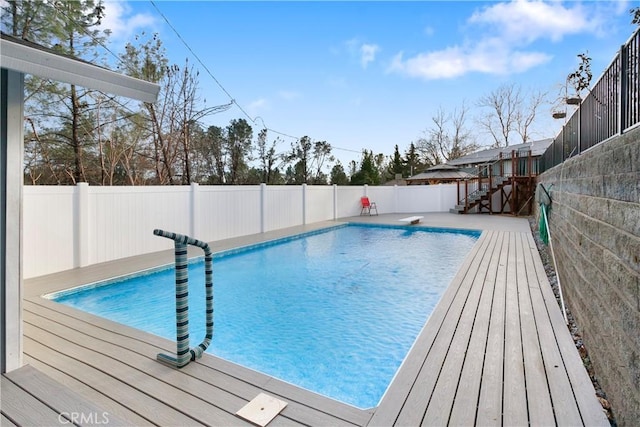 view of pool featuring a diving board