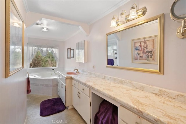 bathroom with vanity, tiled tub, and crown molding