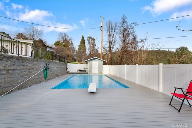 view of pool with a storage unit and a deck