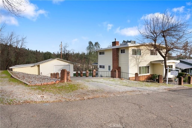 view of home's exterior featuring a garage and an outdoor structure