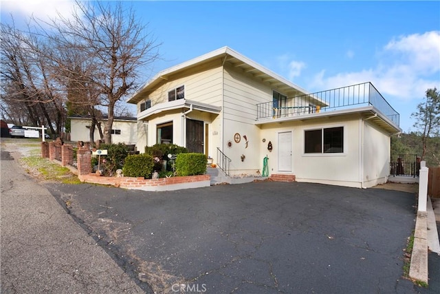 front of property with a balcony