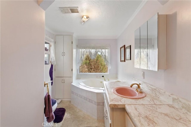 bathroom featuring ornamental molding, a relaxing tiled tub, and vanity