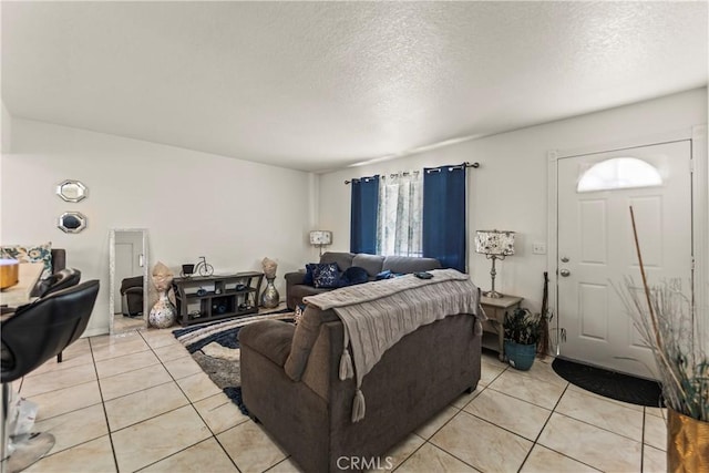 living room with light tile patterned floors and a textured ceiling